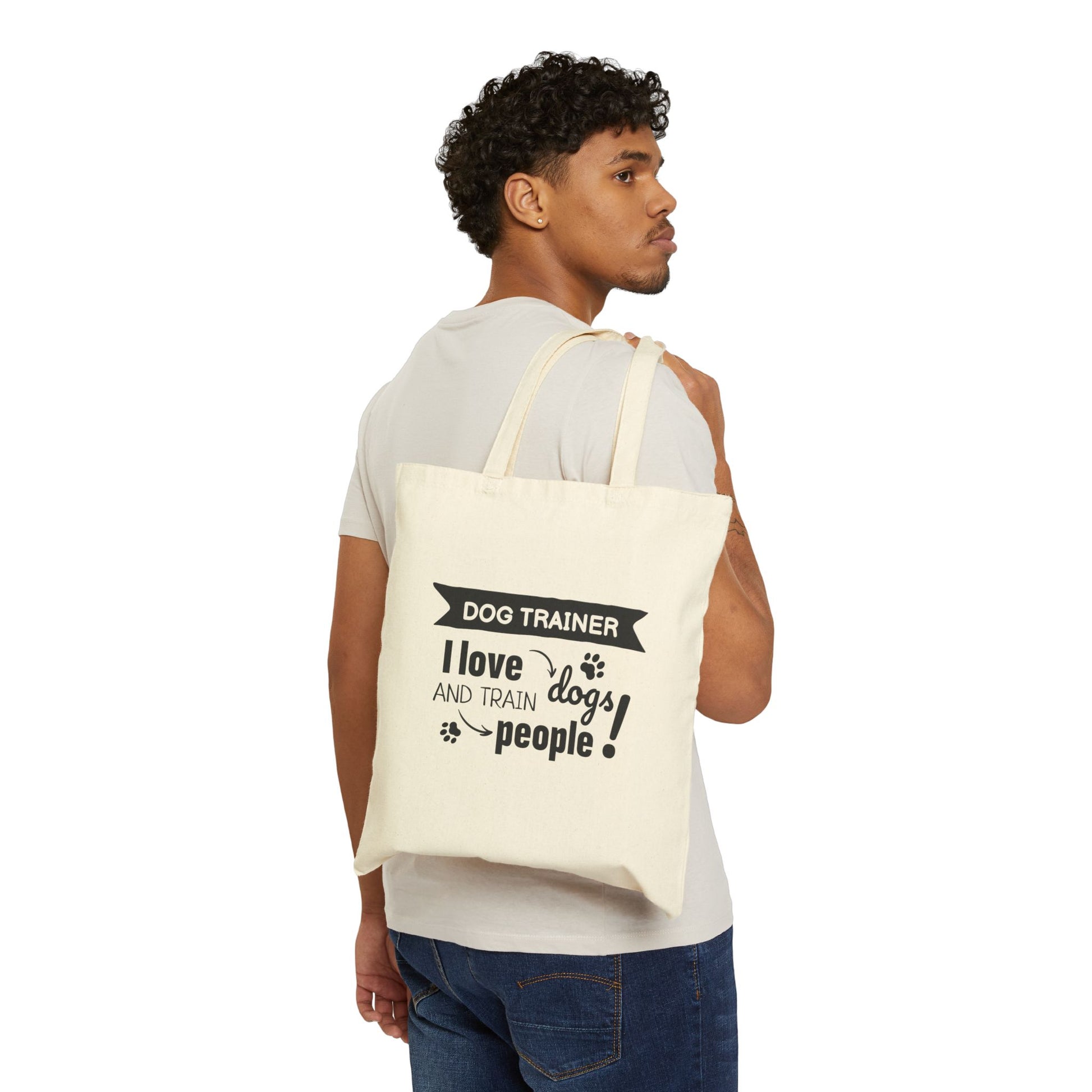 Man carrying a tote bag with 'Dog Trainer' text and design.