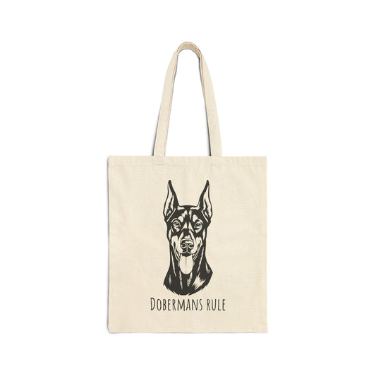 Beige tote bag with a black doberman illustration and 'Dobermans Rule' text on a white background