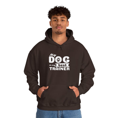 Person wearing a black hoodie with 'My dog is my best trainer' text on a white background