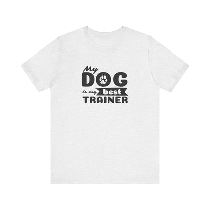 White t-shirt with black text 'My dog is my best trainer' on a white background