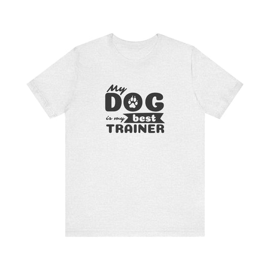 White t-shirt with black text 'My dog is my best trainer' on a white background