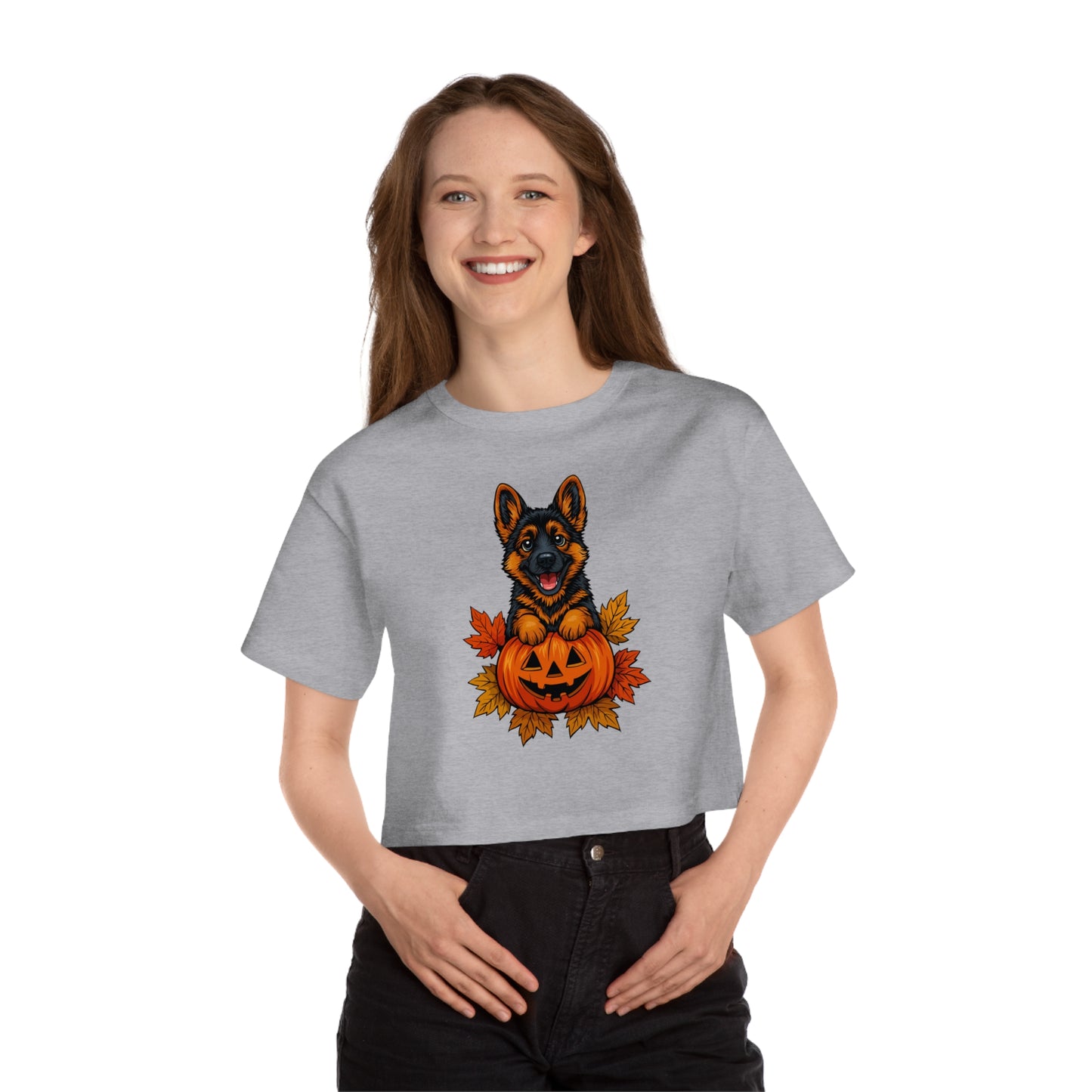 Person wearing a gray t-shirt with a graphic of a dog and pumpkin, on a white background