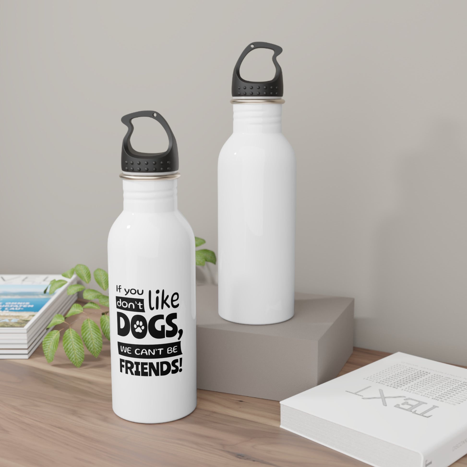 Two white water bottles with black text on a wooden surface.