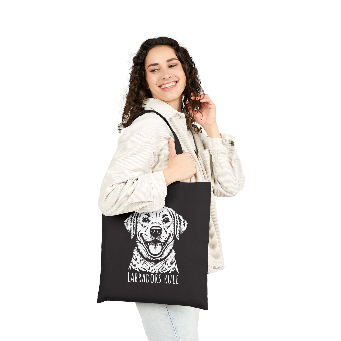 Woman holding a black tote bag with a Labrador design and 'Labradors Rule' text on a white background