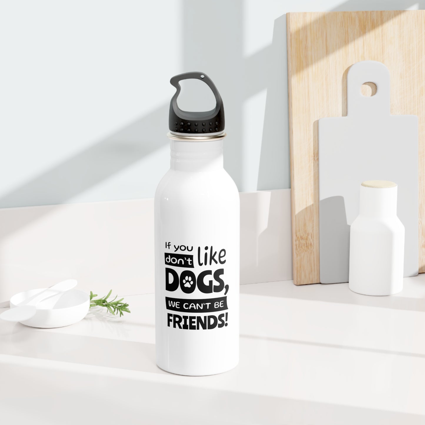 White water bottle with black text on a white surface with wooden cutting boards in the background