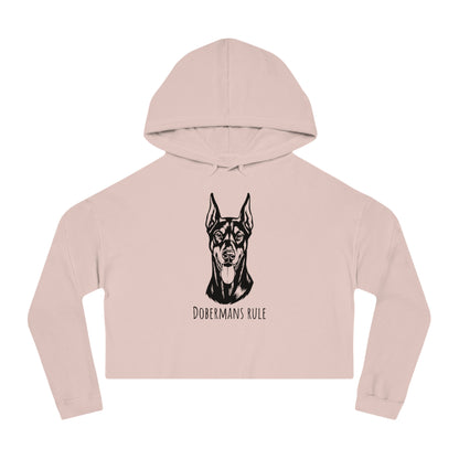 Pink cropped hoodie with a black doberman graphic and 'Dobermans Rule' text on a white background