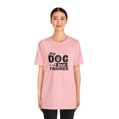Person wearing a pink t-shirt with 'My dog is my best trainer' text on a white background