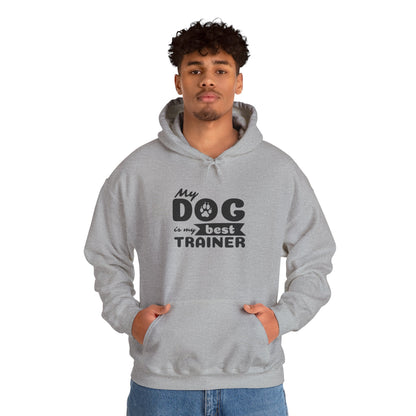 Person wearing a gray hoodie with 'My dog is my best trainer' text on a white background