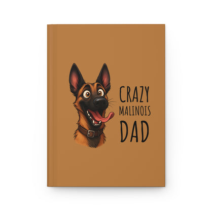 Notebook with a dog illustration and text 'Crazy Malinois Dad' on a brown background