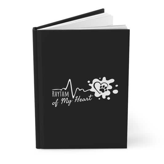 Black notebook with 'Rhythm of My Heart' design on a white background