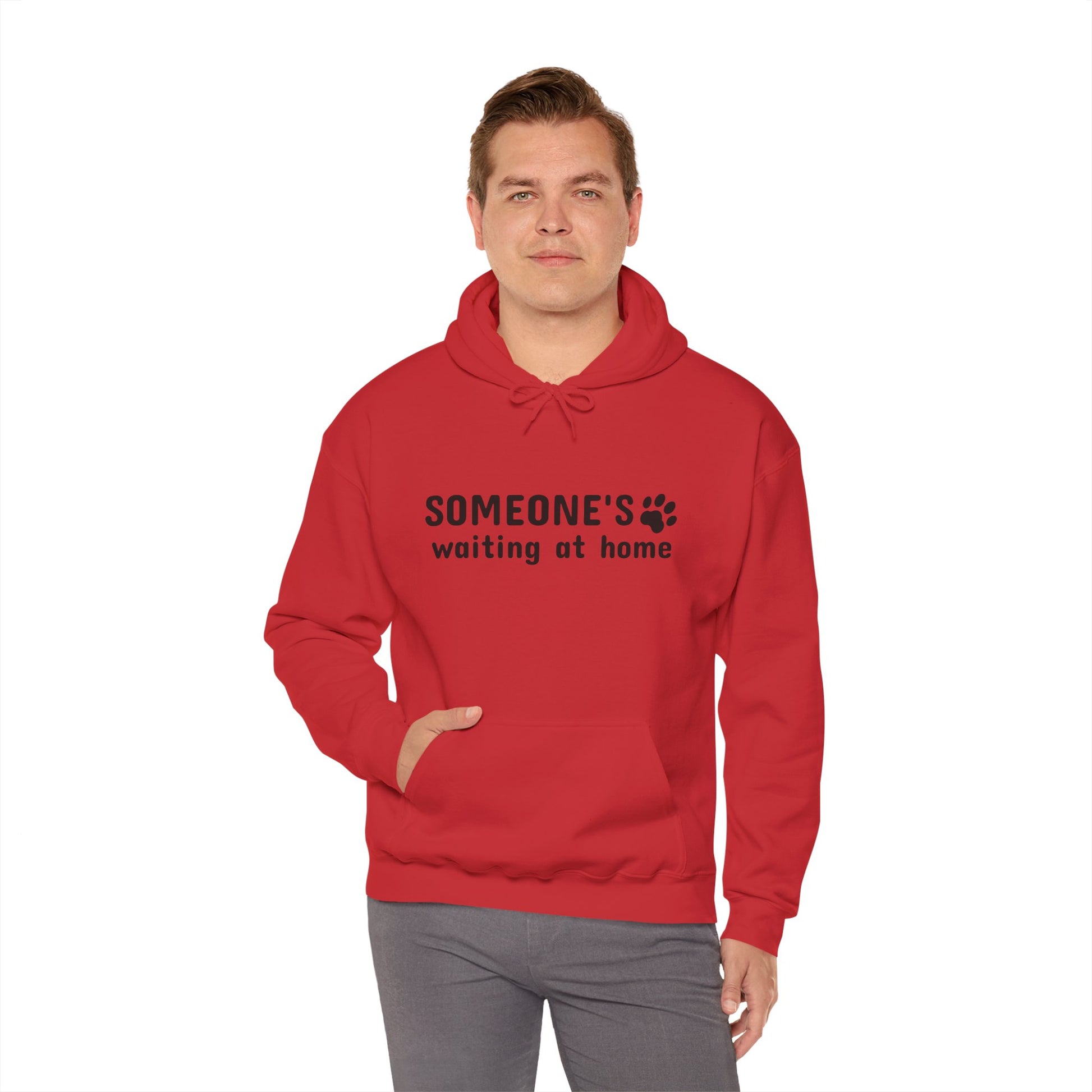 Man wearing a red hoodie with text and paw print design on a white background