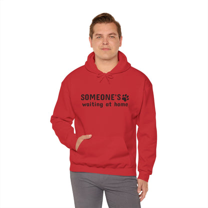 Man wearing a red hoodie with text and paw print design on a white background