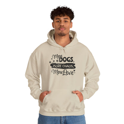 Person wearing a beige hoodie with text 'More Dogs, More Chaos, More Love' on a white background