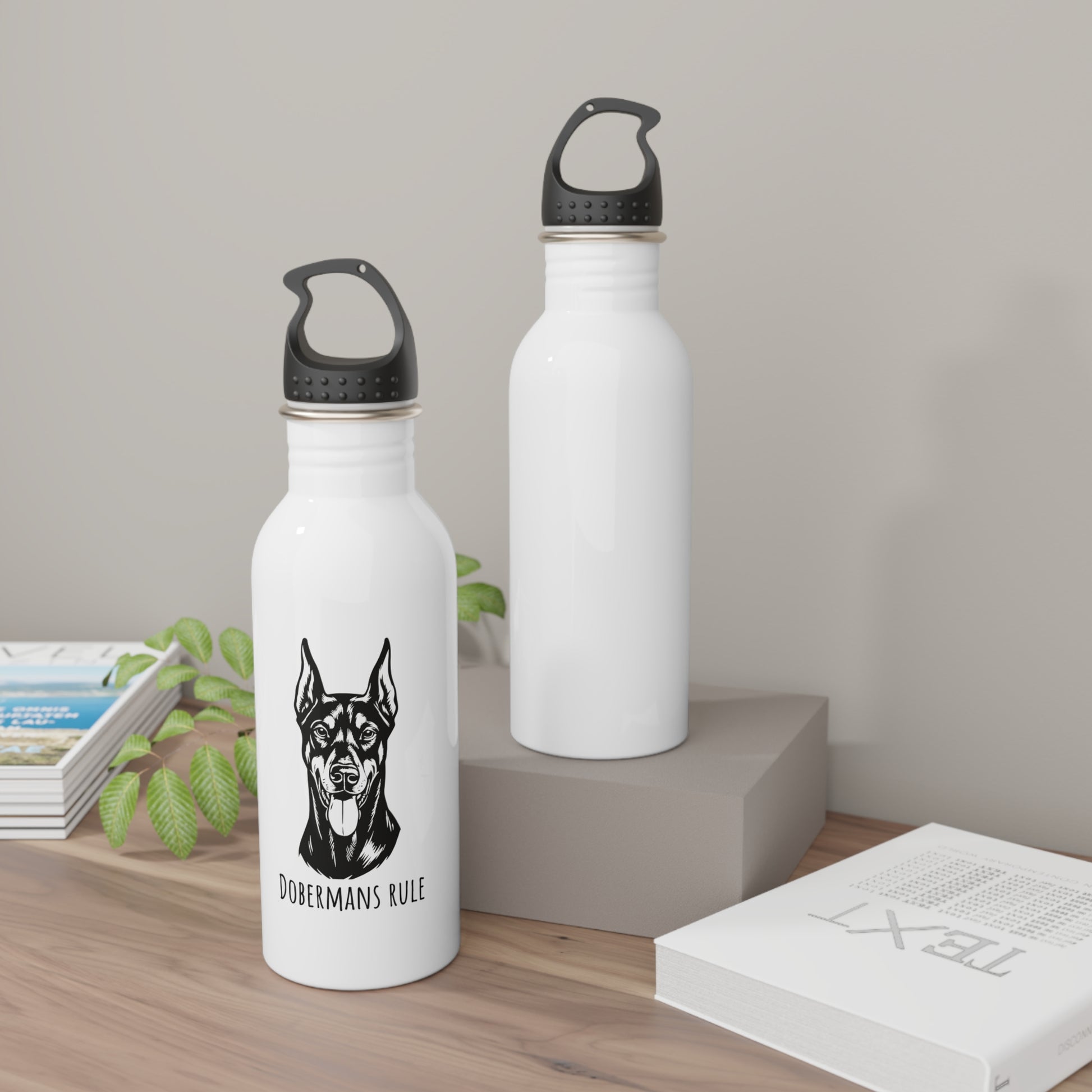 Two white water bottles with black dog illustrations and text on a wooden surface.