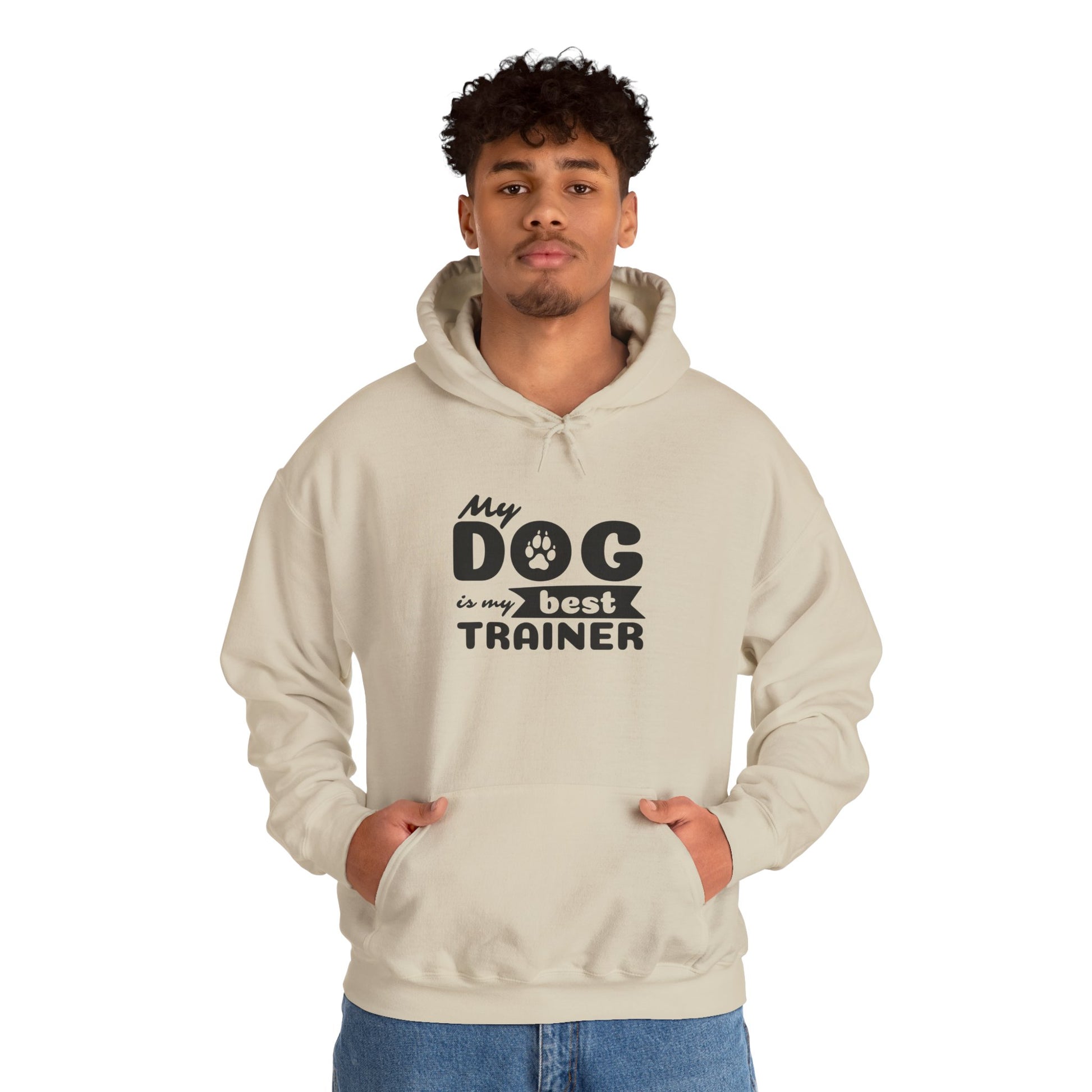 Person wearing a beige hoodie with text 'My dog is my best trainer' on a white background