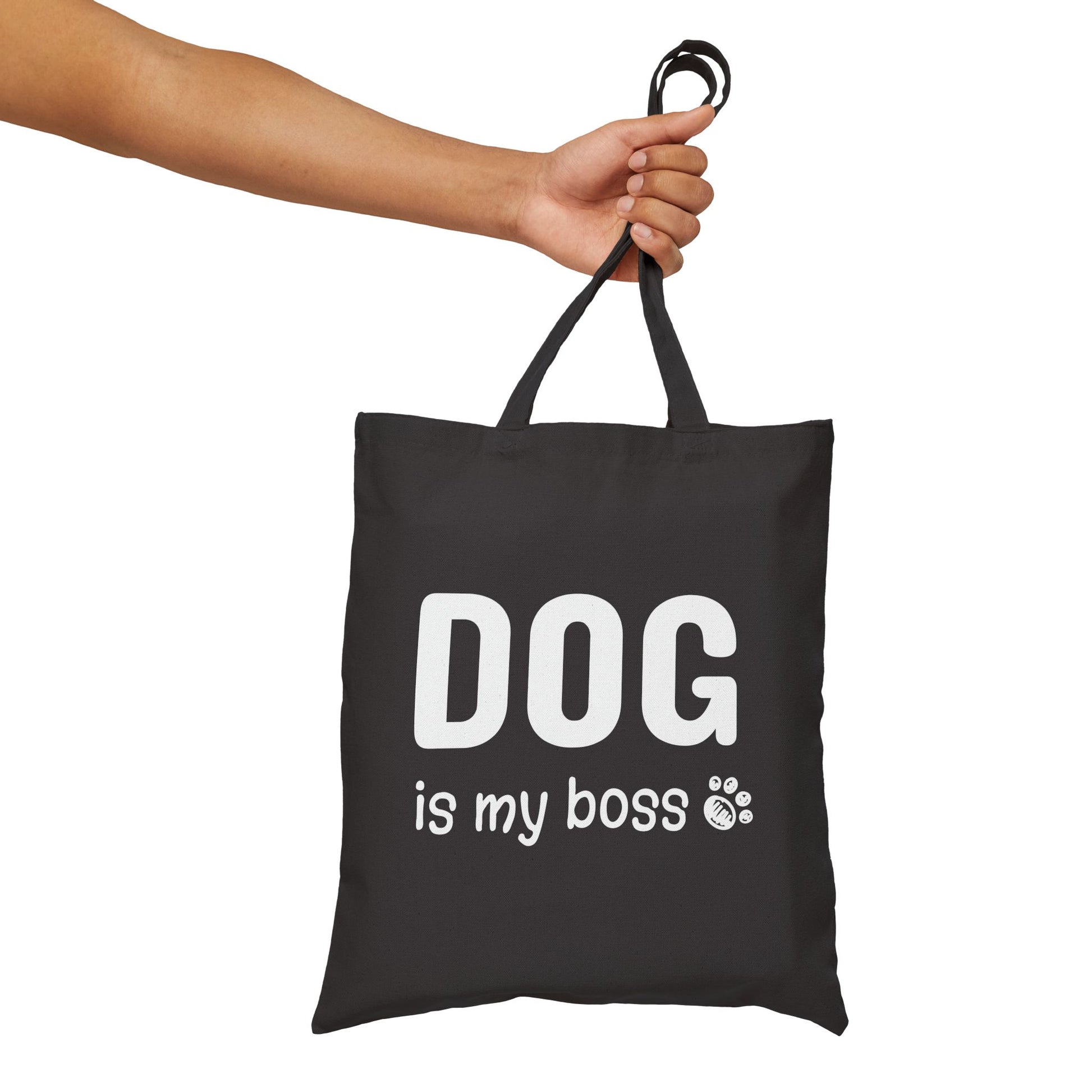 Black tote bag with 'DOG is my boss' text held by a hand on a white background