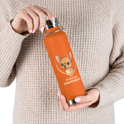 Person holding an orange water bottle with a dog illustration and text.