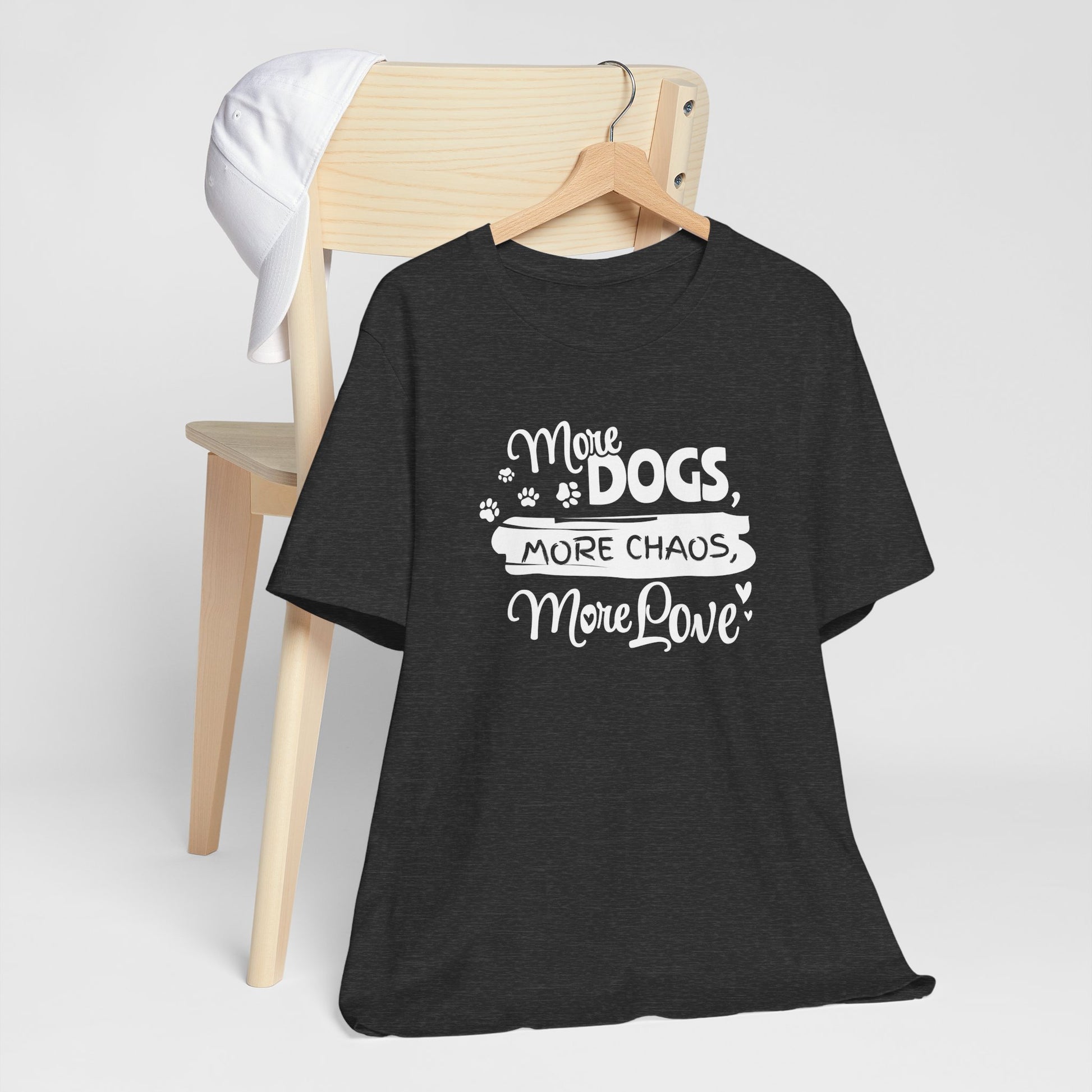 Black t-shirt with 'More Dogs, More Chaos, More Love' text on a white background