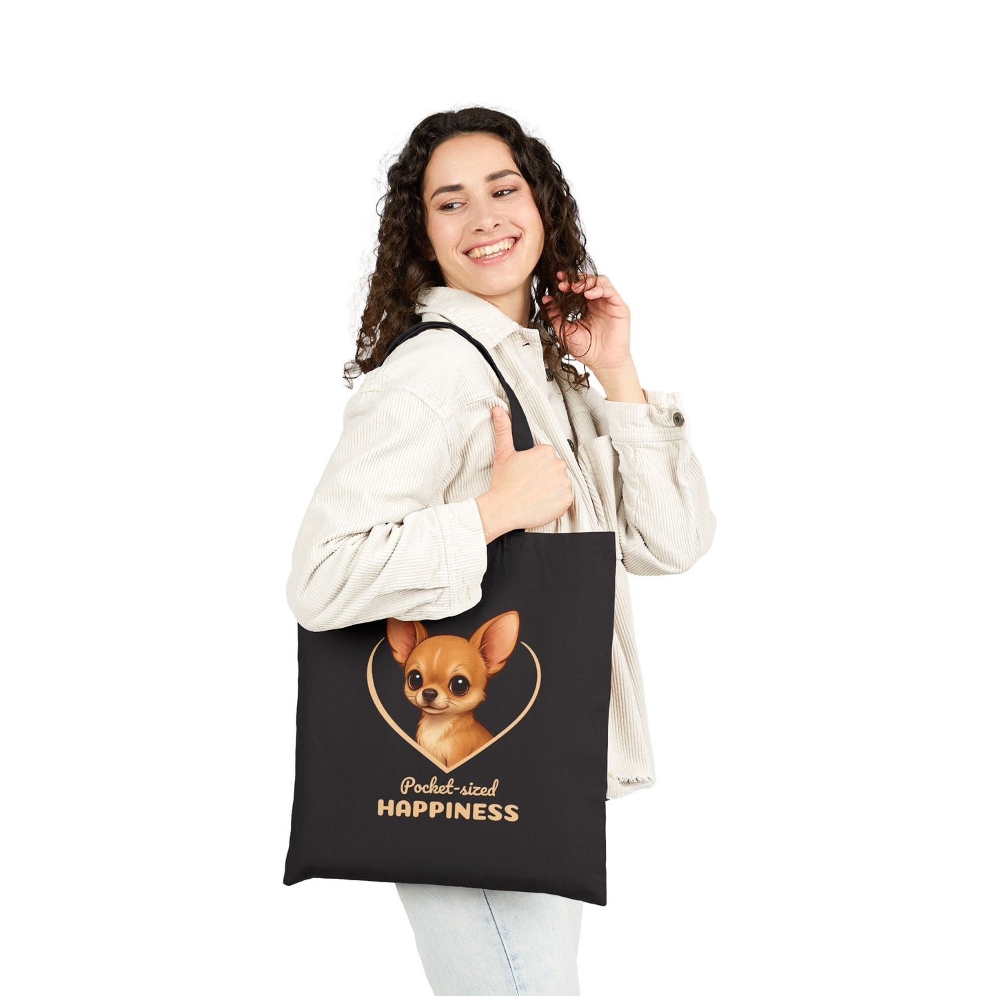 Woman holding a black tote bag with a dog illustration and text on a white background