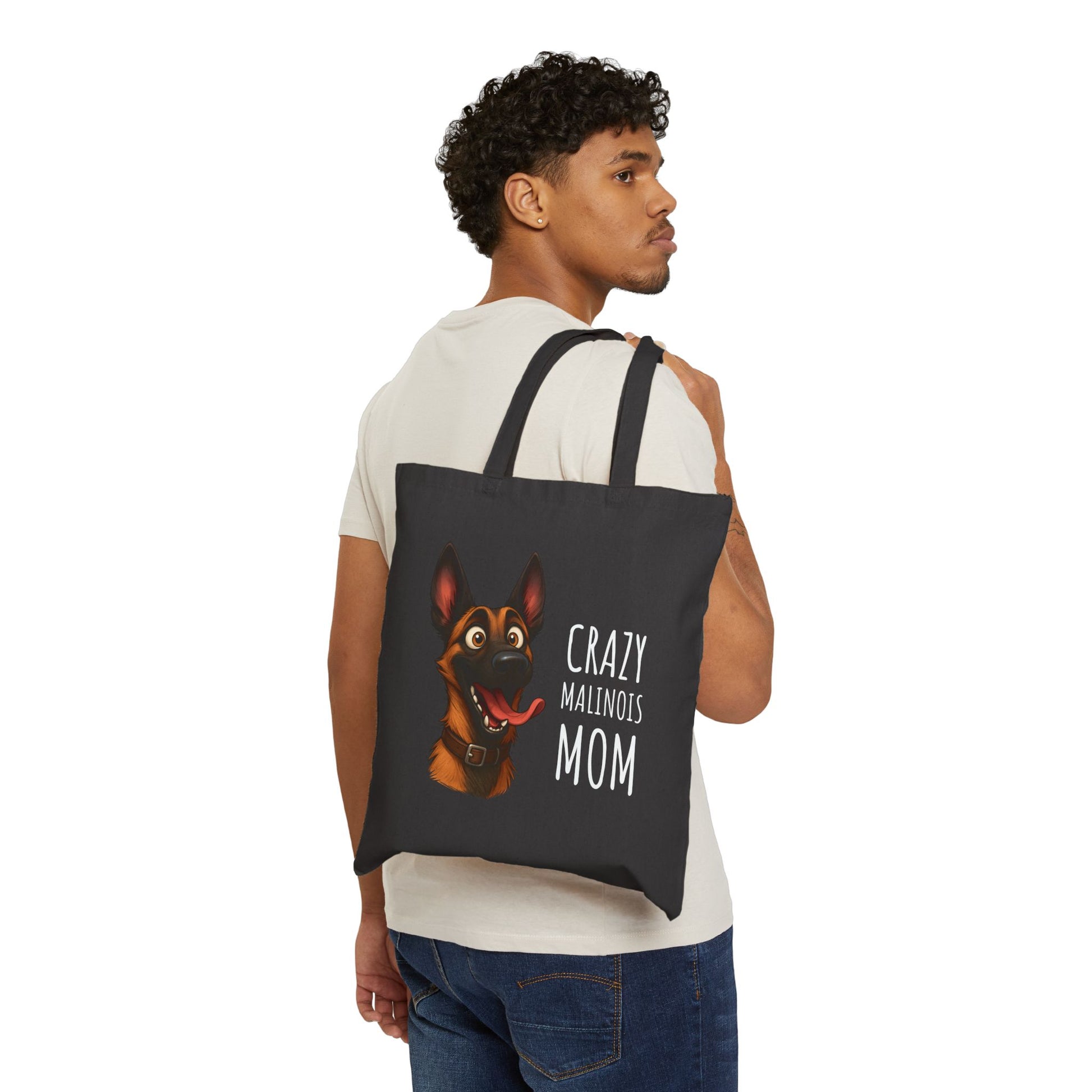 Person carrying a black tote bag with a dog illustration and text on a white background
