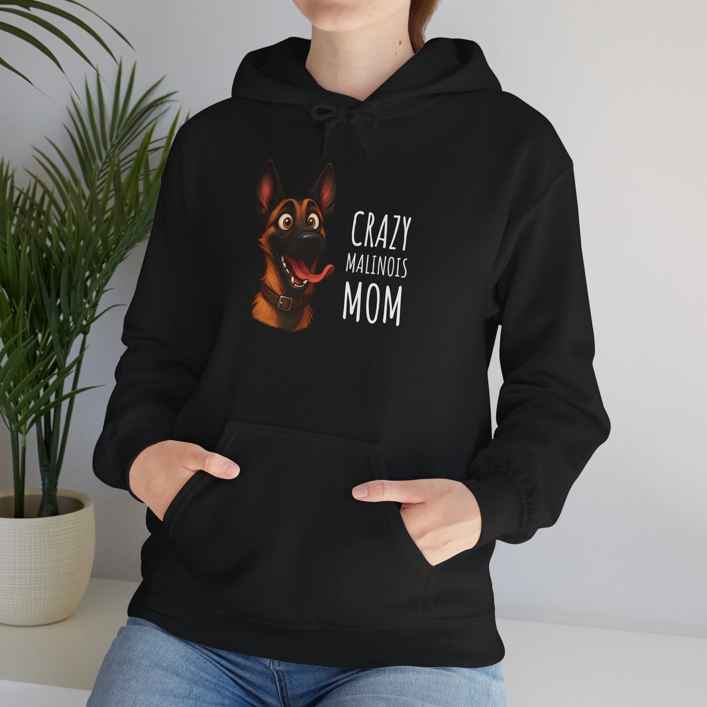 Person wearing a black hoodie with a dog graphic and text, standing indoors.