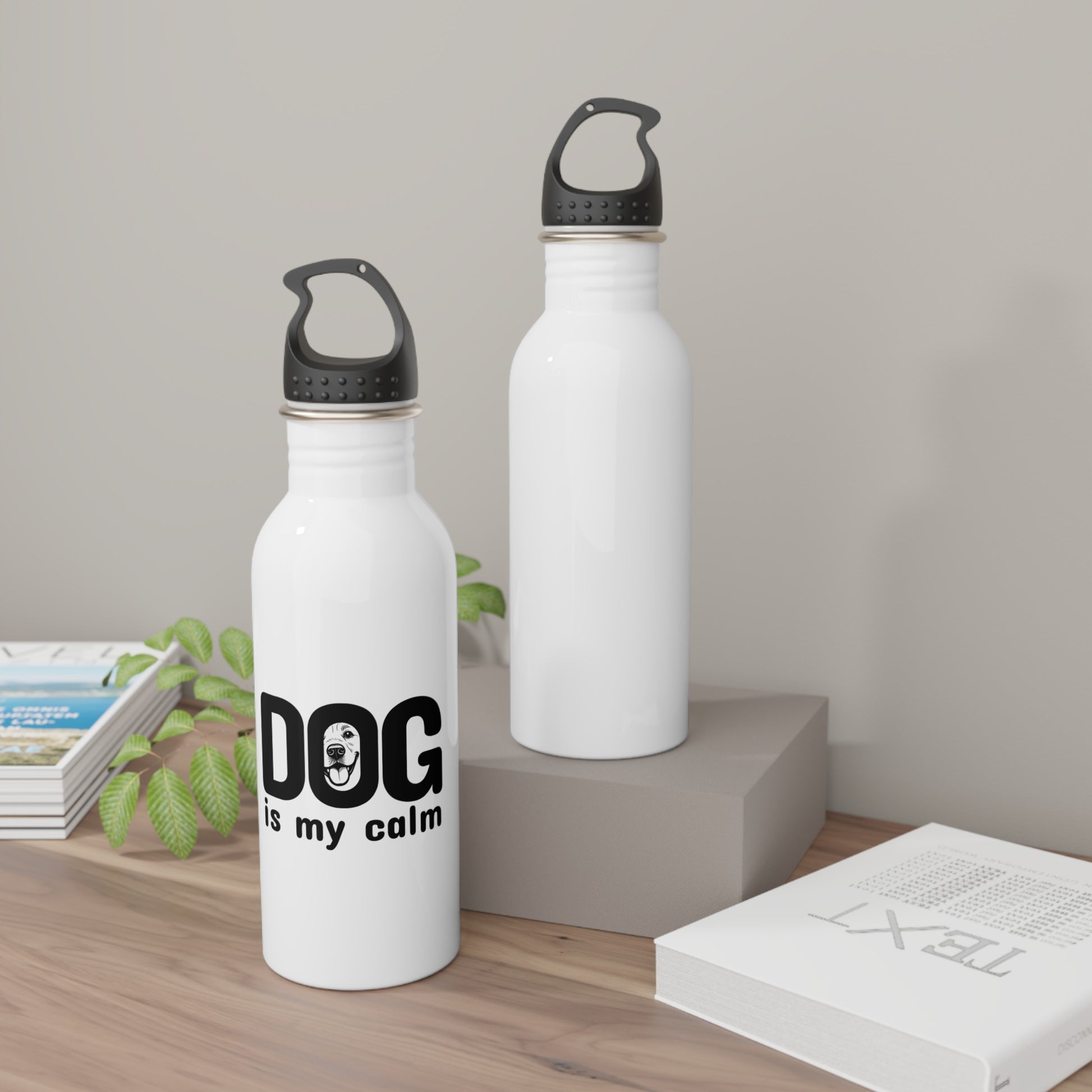 Two white water bottles with black text on a wooden surface.