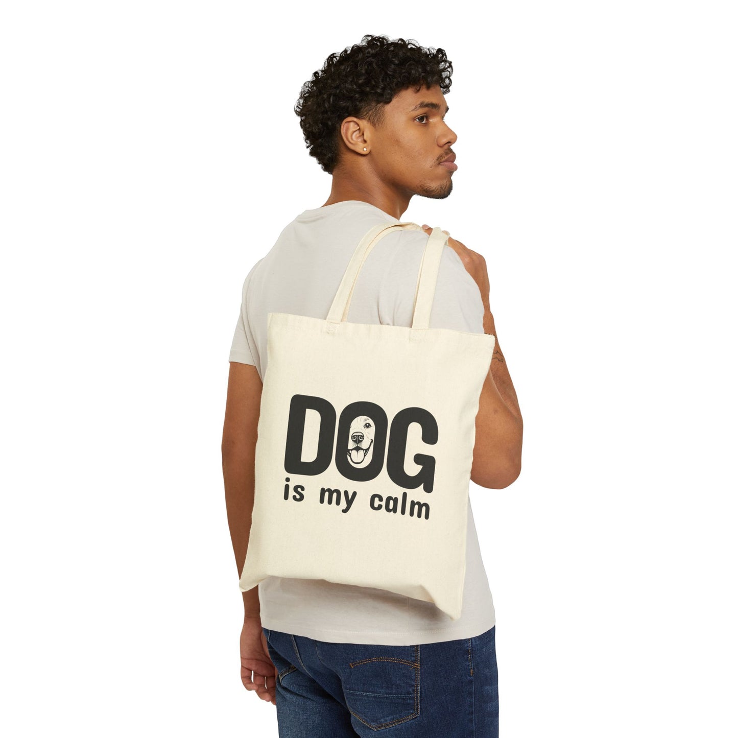 Man carrying a tote bag with 'DOG is my calm' text on a white background