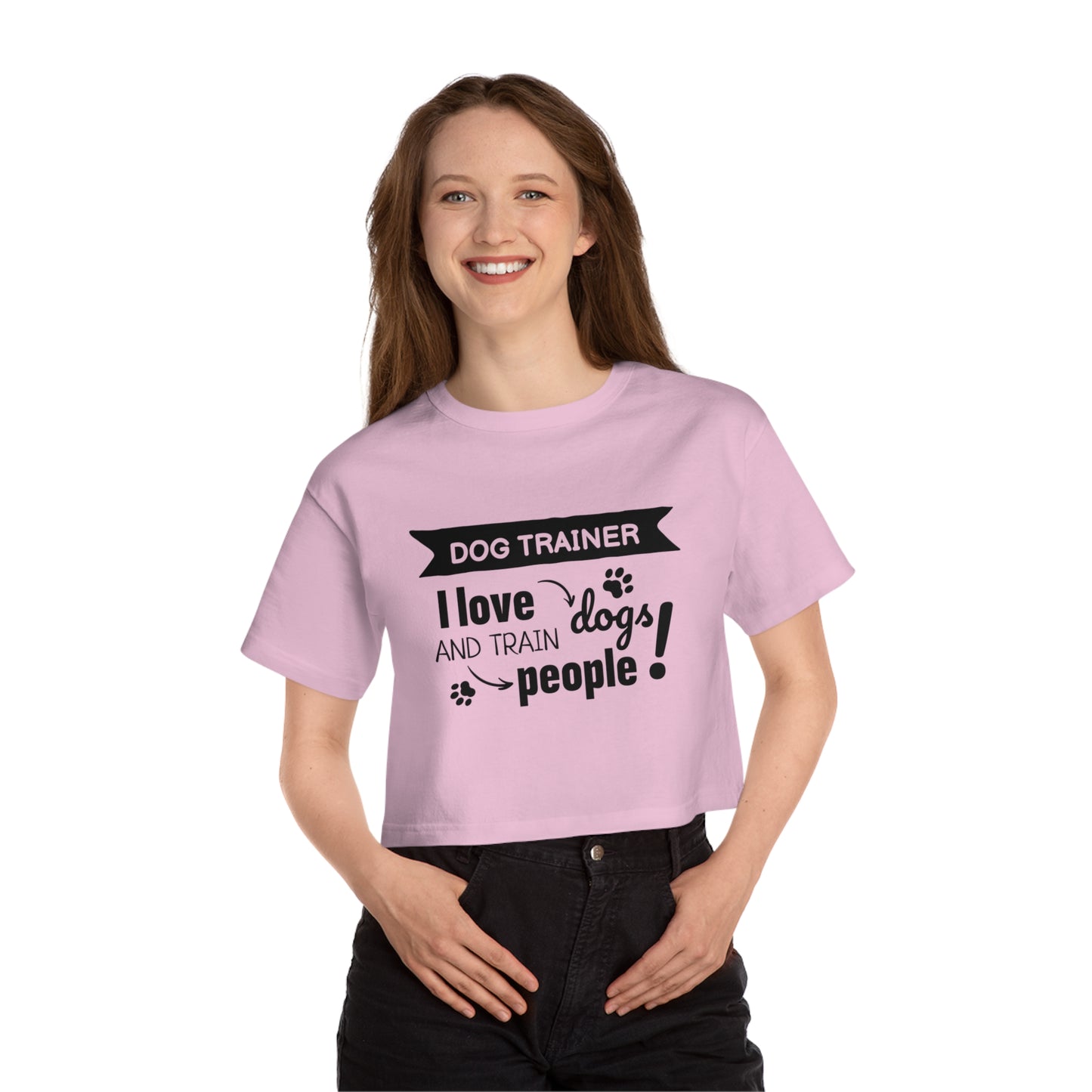 Woman wearing a pink t-shirt with text 'Dog Trainer I love dogs and train people' on a white background