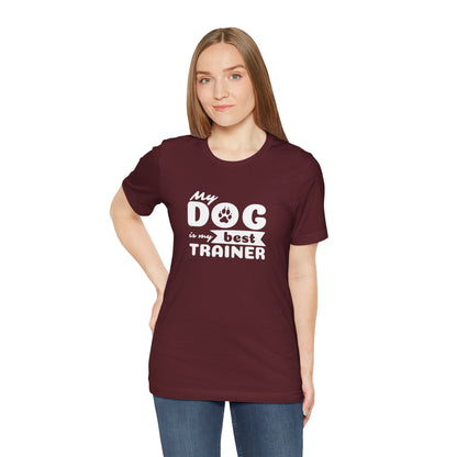 Woman wearing a maroon t-shirt with 'My dog is my best trainer' text on a white background