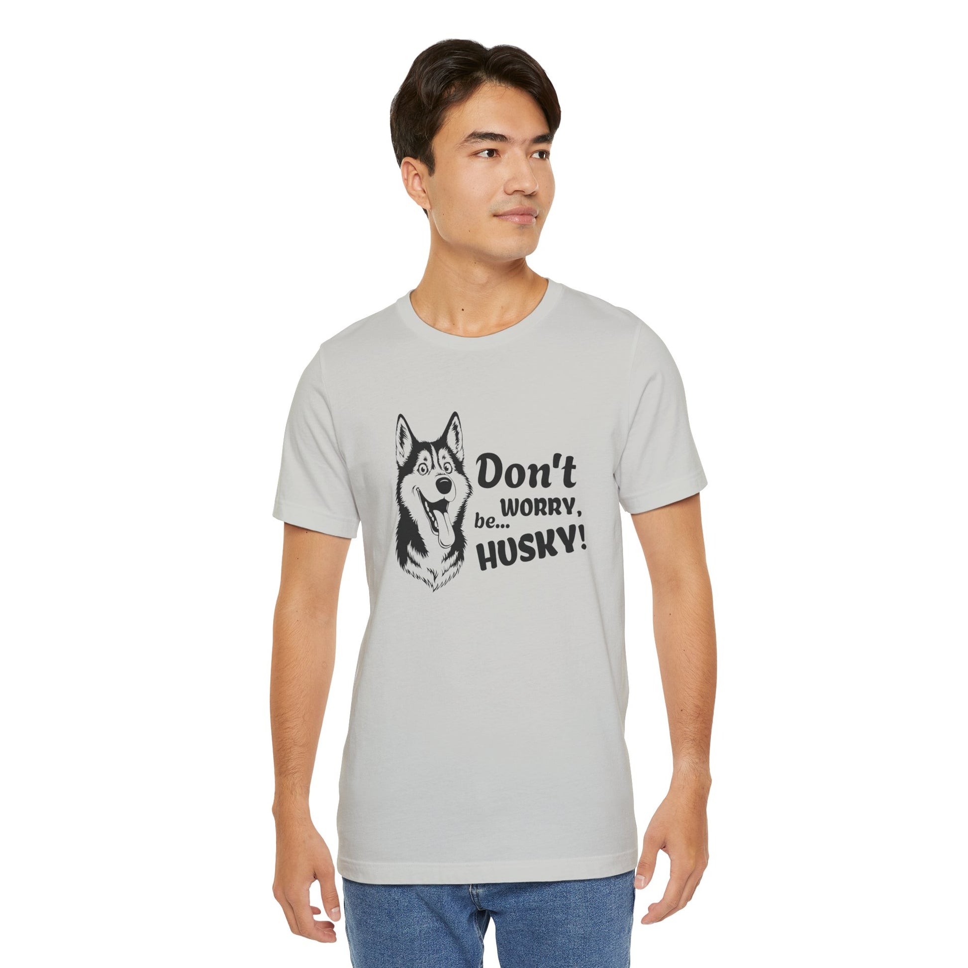Man wearing a gray t-shirt with a husky graphic and text on a white background