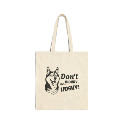 Beige tote bag with husky illustration and text on a white background