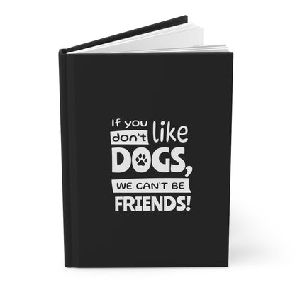 Black notebook with white text 'If you don't like dogs, we can't be friends!' on a white background