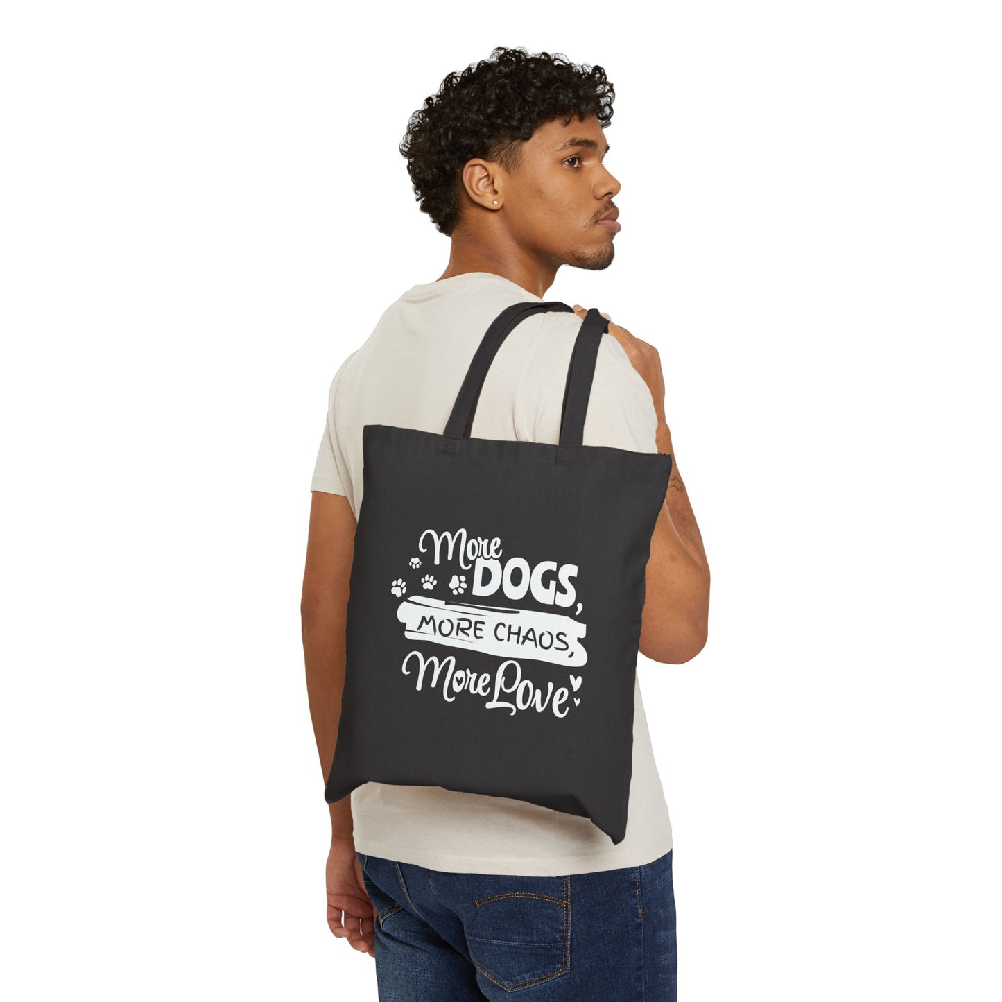 Man carrying a black tote bag with white text and graphics on a white background