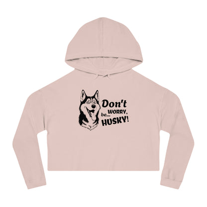 Pink cropped hoodie with husky graphic and text on a white background