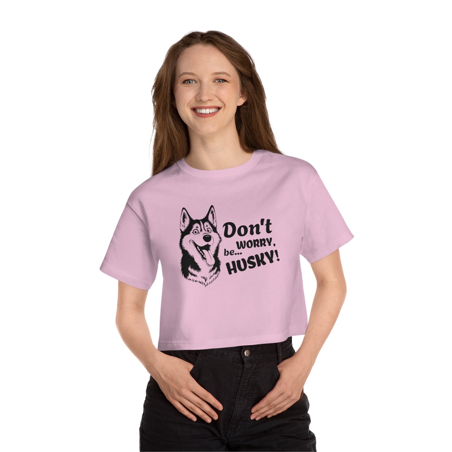 Person wearing a pink t-shirt with a husky graphic and text on a white background