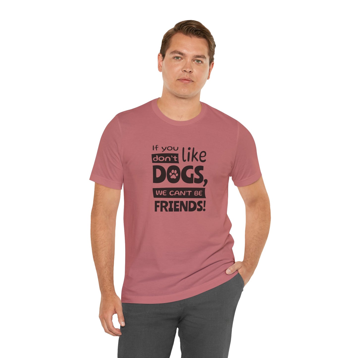 Man wearing a pink t-shirt with a humorous dog-themed message on a white background