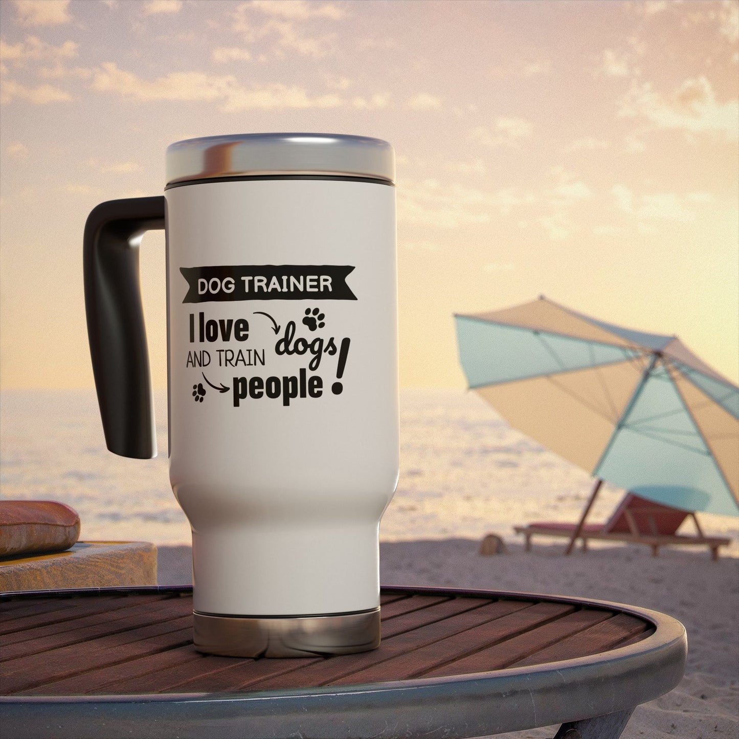 White travel mug with black text on a beach setting