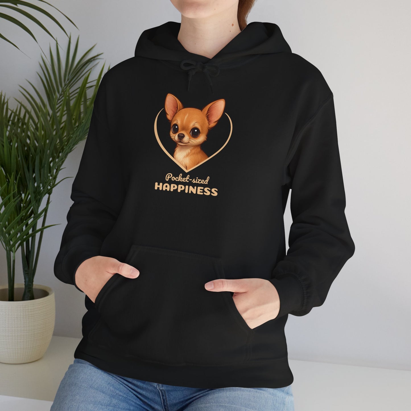 Person wearing a black hoodie with a dog graphic and text in a home setting