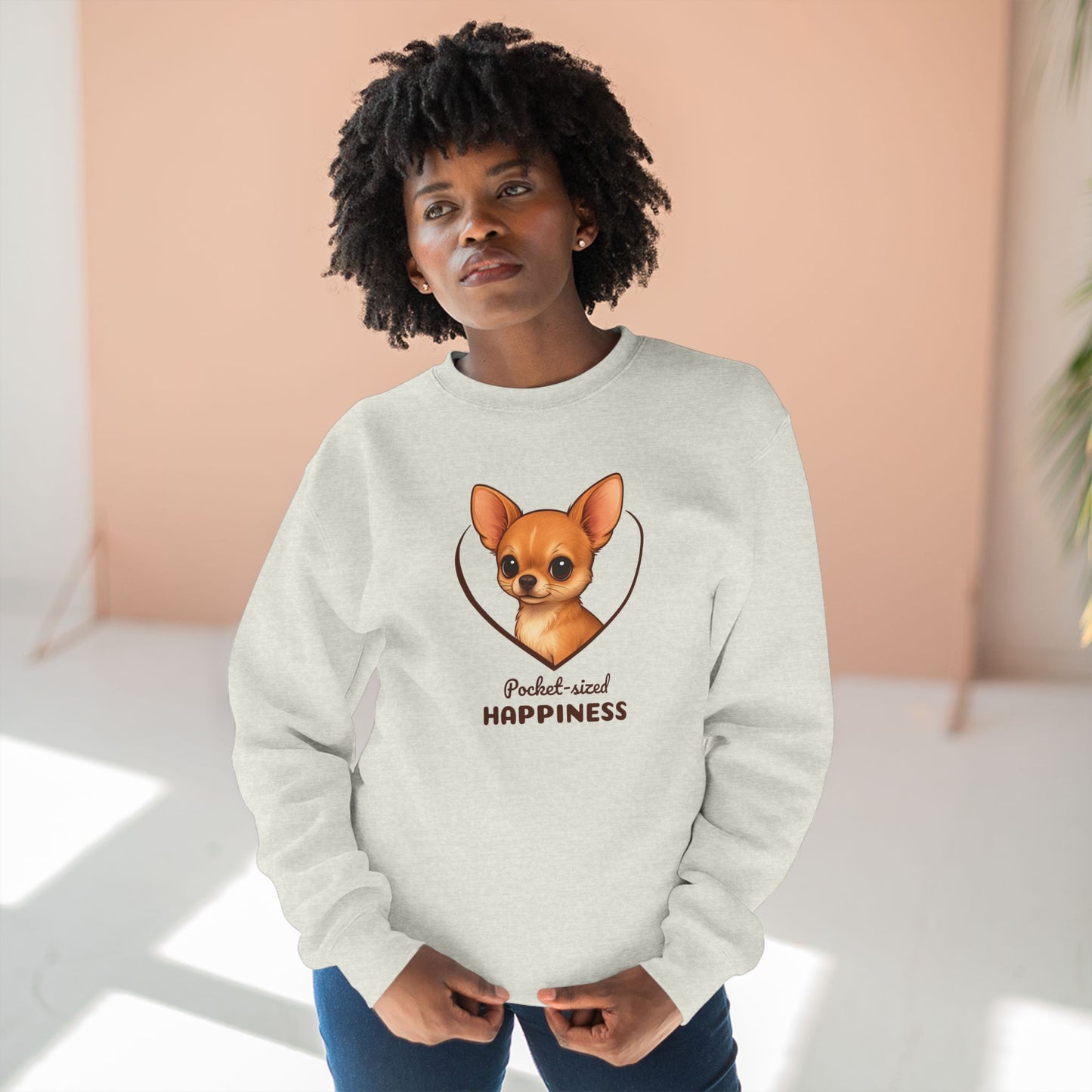 Person wearing a white sweatshirt with a dog illustration and text
