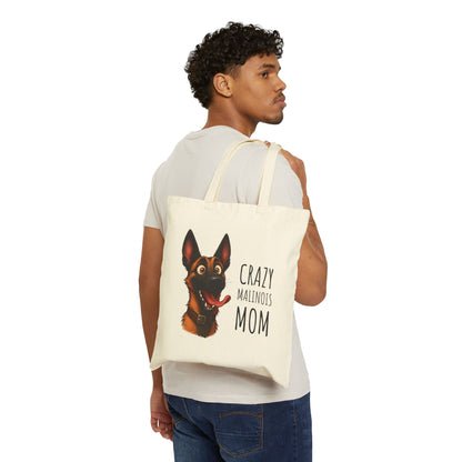 Person holding a tote bag with a dog illustration and text on a white background